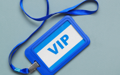 VIP badge and printed materials on a welcome table